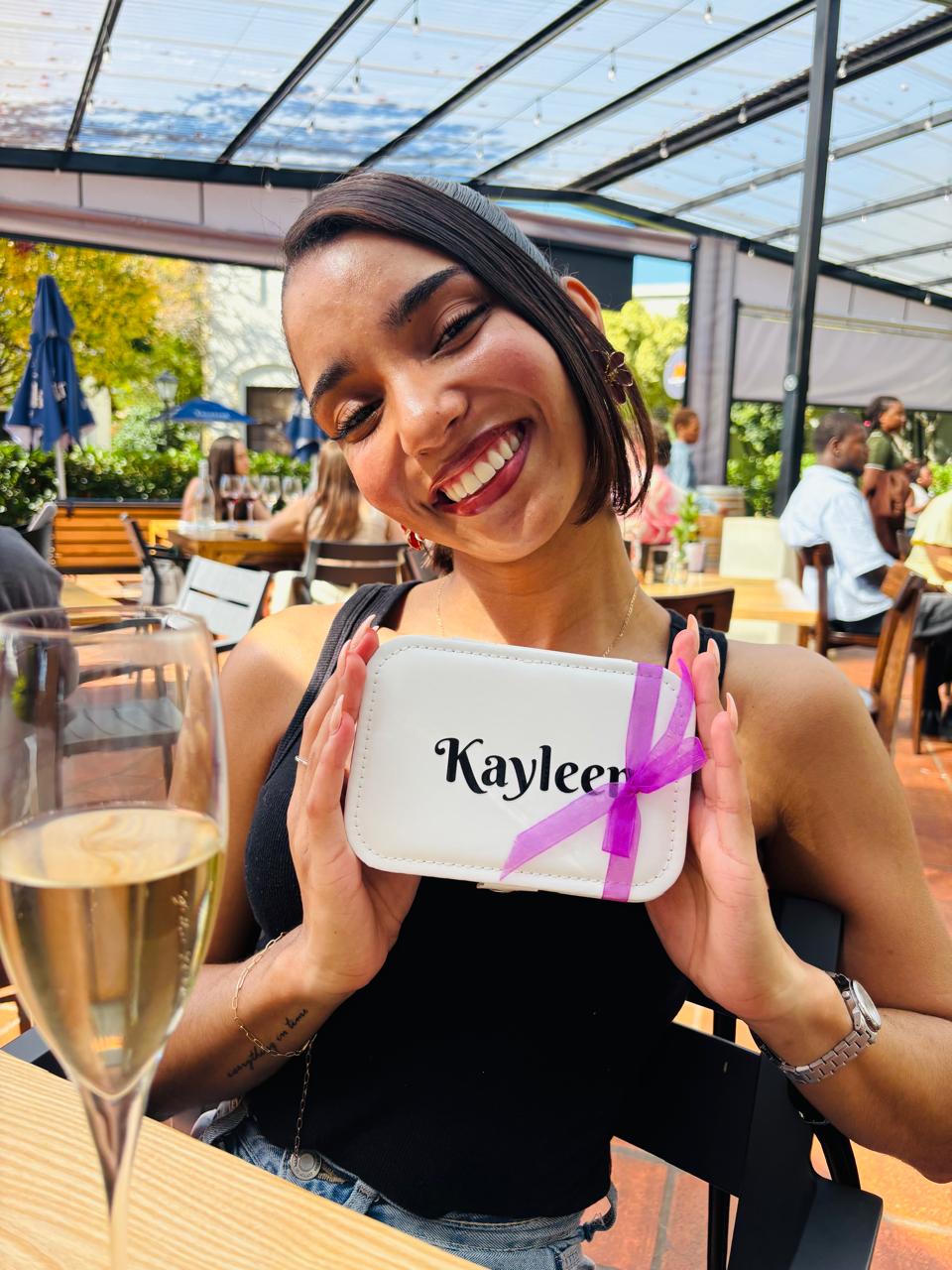 Guest smiling and holding a personalised welcome gift